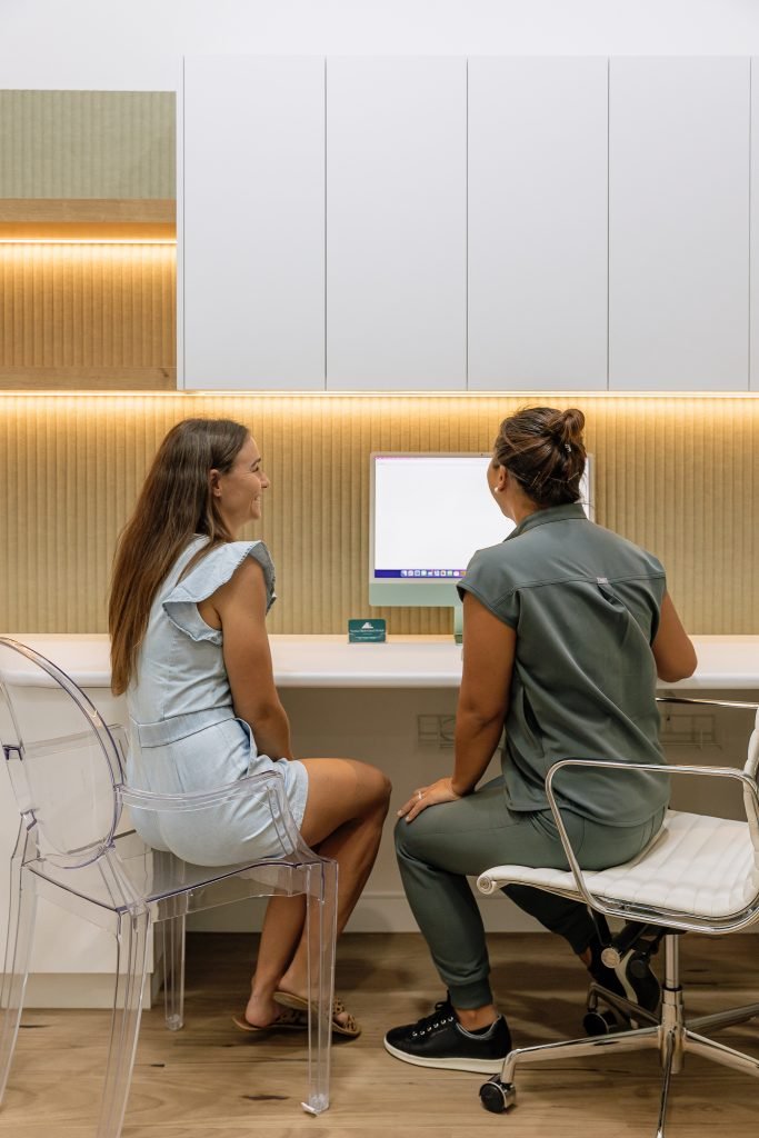 Patient and dental professional discussing treatment at Noosa Hinterland Dental consultation desk