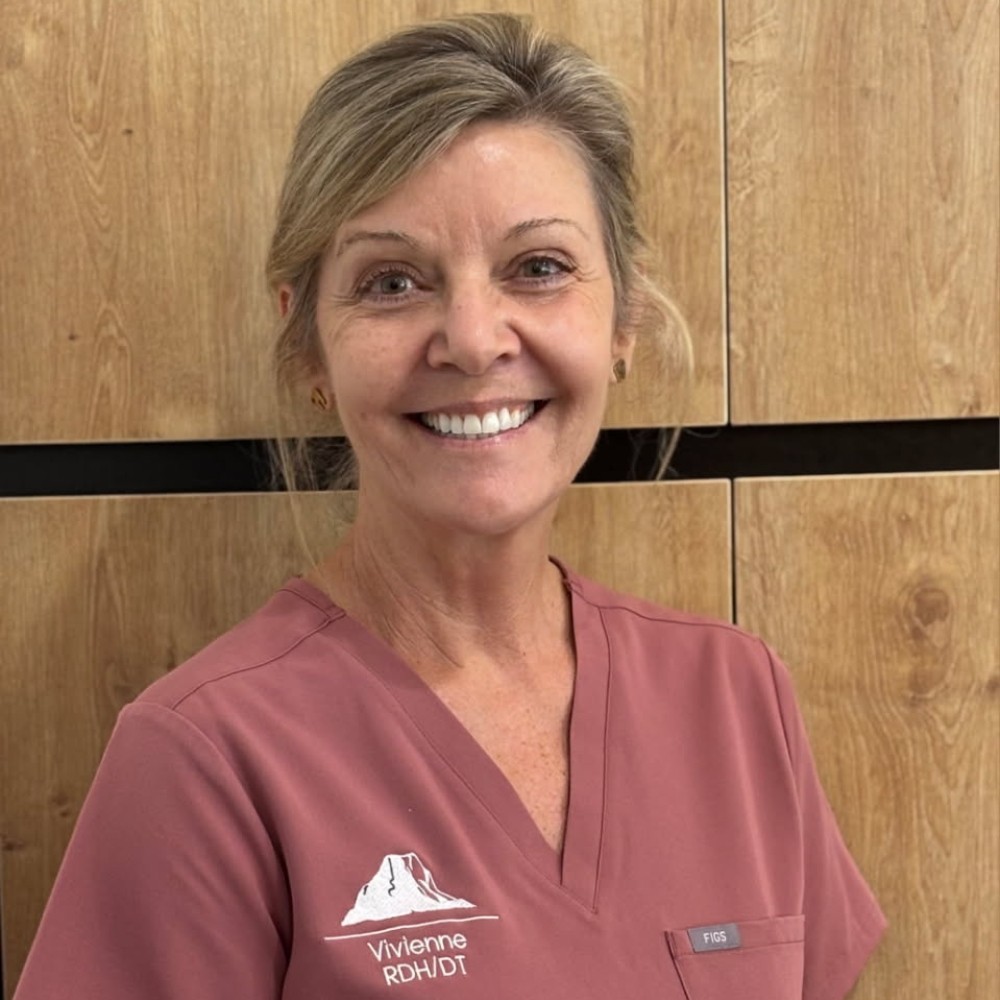 Portrait of Vivienne Cunningham, dental hygienist and therapist at Noosa Hinterland Dental, smiling in her clinic uniform.