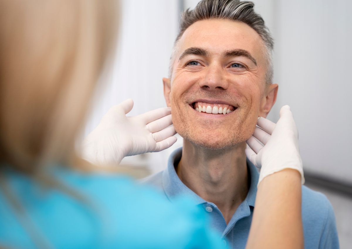 Dentist examining patient during full mouth rehabilitation consultation