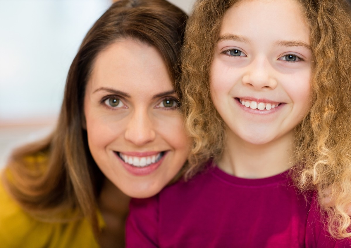 Mother and daughter smiling at a Pomona family dentist clinic